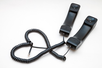 Telemarketing Services Passion - two handsets with their cords in the shape of a heart