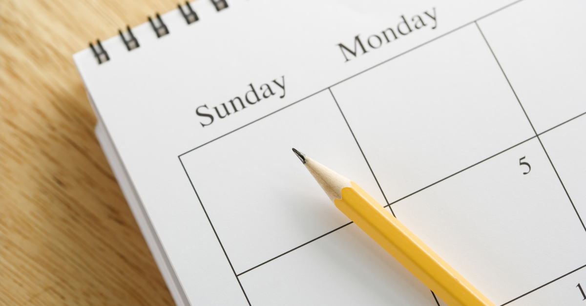 an appointment setting calendar on a table with a pencil pointing to Sunday